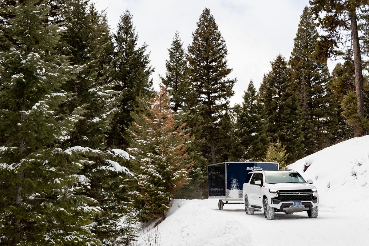 High Country Enclosed Crossover 2.0 Snow Trailer Driving Down Snowy Road