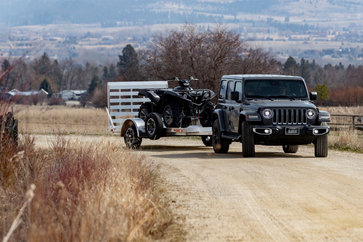 Jeep Hauling High Country Open Utility AR 2.0 Trailers On Dirt Road